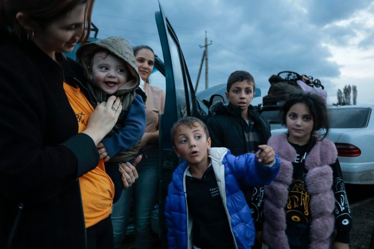 Ethnic Armenians from Nagorno-Karabakh wait to drive to Kornidzor, the town in Syunik region, Armenia, Monday, Sept. 25, 2023. 