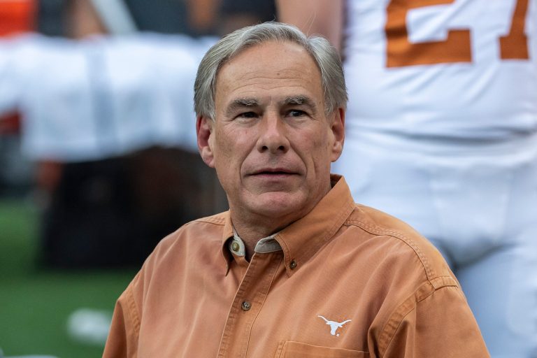 Gov. Greg Abbott (R-TX) visits the field during warmups before an NCAA college football game between Texas and Alabama, Sept. 9, 2023, in Tuscaloosa, Alabama.