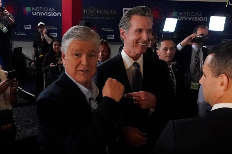 Gov. Gavin Newsom (D-CA) jokes with commentator Sean Hannity in the spin room before a Republican presidential primary debate, Sept. 27, 2023.