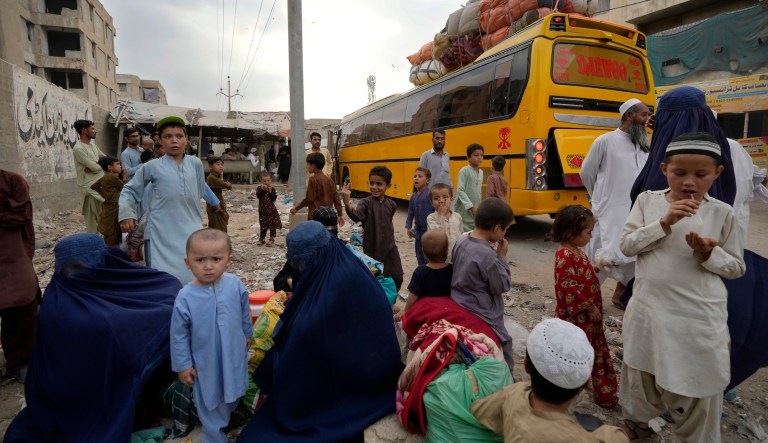 Afghan families wait to board into a bus to depart for their homeland, in Karachi, Pakistan, Friday, Oct. 6, 2023. Pakistan's government announced a major crackdown Tuesday on migrants in the country illegally, saying it would expel them starting next month and raising alarm among foreigners without documentation who include an estimated 1.7 million Afghans.