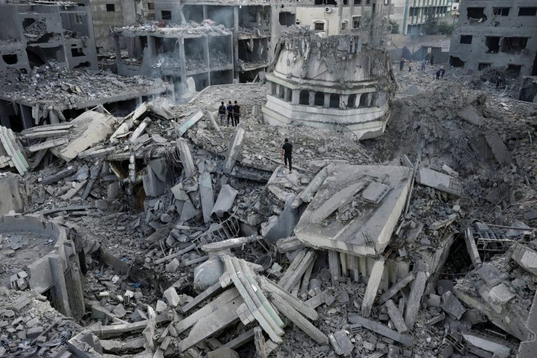 Palestinians inspect the rubble of the Yassin Mosque destroyed after it was hit by an Israeli airstrike in Gaza City early on Monday, Oct. 9, 2023. Israel's military battled to drive Hamas fighters out of southern towns and seal its borders Monday as it pounded the Gaza Strip.