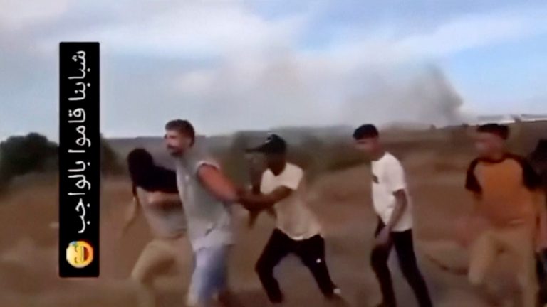 In this image from video obtained by the AP, Avinatan Or, second left, and his partner, Noa Argamani, not pictured, are seized by members of the Hamas militant group during an incursion into Israel on Saturday, Oct. 7, 2023. 