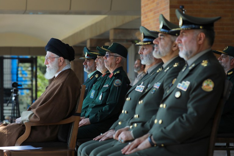 In this picture released by the official website of the office of the Iranian supreme leader, Supreme Leader Ayatollah Ali Khamenei, left, attends a graduation ceremony for a group of armed forces cadets in Tehran, Iran, Tuesday, Oct. 10, 2023. 