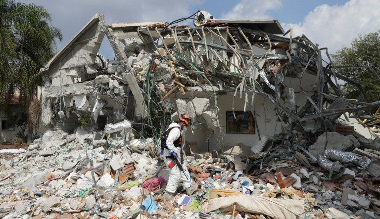 An Israeli soldier walks by a house destroyed by Hamas terrorists in Kibbutz Be'eri on Wednesday, Oct. 11, 2023. The kibbutz was overrun by Hamas terrorists from the nearby Gaza Strip Saturday when they killed and captured many Israelis.