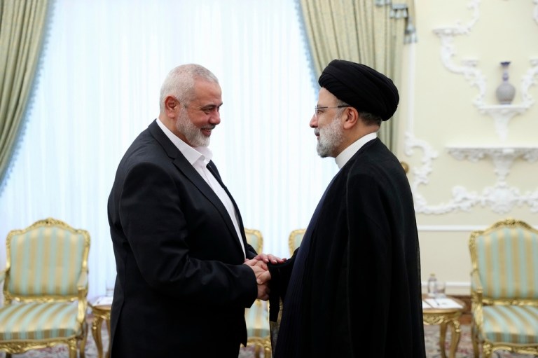 In this photo released by the Iranian Presidency Office, President Ebrahim Raisi, right, greets the leader of the Palestinian militant group Hamas, Ismail Haniyeh.