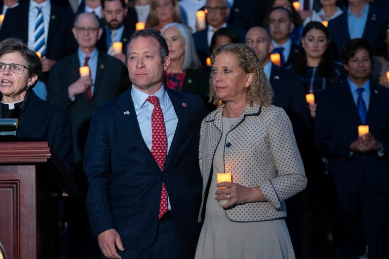 Rep. Josh Gottheimer (D-NJ, left) and Rep. Debbie Wasserman Schultz (D-FL) have a moment of silence along with other members of Congress as they host a candlelight vigil for Israel at the Capitol in Washington, Thursday, Oct. 12, 2023. 