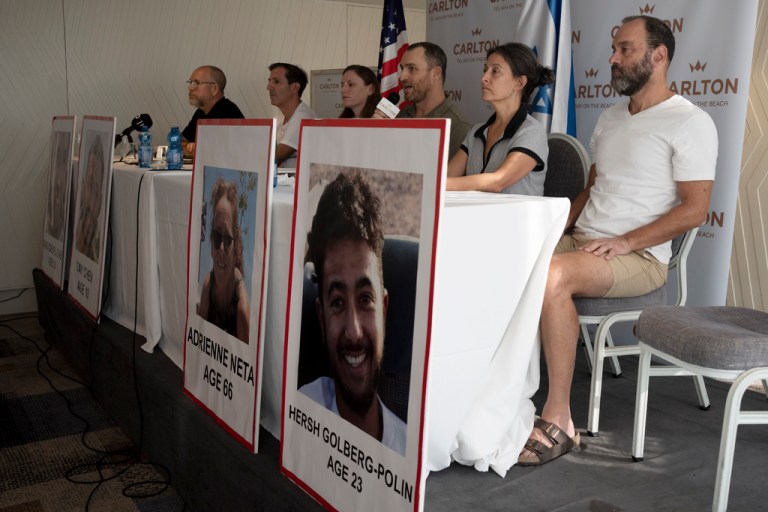 Rachel Goldberg, mother of Hersh Goldberg-Polin, 23, and Jonathan Polin are seen at right with a poster displaying Hersh Goldberg-Polin's photo at a news conference on Oct. 10, 2023.
