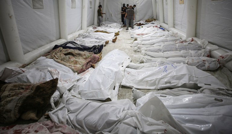 Bodies of Palestinians killed by an Israeli airstrike that hit the Ahli Arab hospital are seen gathered at the front yard of the al Shifa hospital in Gaza City, central Gaza Strip, on Tuesday, Oct. 17, 2023. 