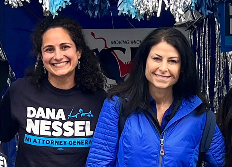 In this photo released by Kimberly Bush, Samantha Woll, left, poses with Michigan Attorney General Dana Nessel on Sept. 4, 2022, in Royal Oak, Mich. 