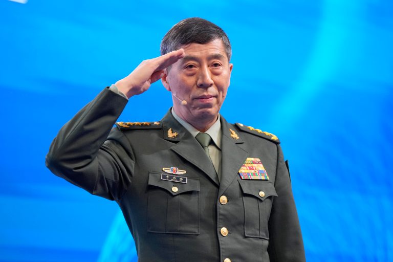 Chinese Defense Minister Li Shangfu salutes before delivering his speech on the last day of the 20th International Institute for Strategic Studies Shangri-La Dialogue, Asia's annual defense and security forum, in Singapore, on June 4, 2023. China has replaced Li, who has been out of public view for almost two months with little explanation, state media reported Tuesday, Oct. 24. 