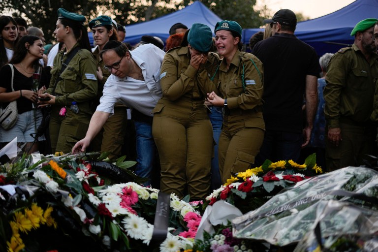 Mourners gather around the graves of Sgt. Yam Goldstein and her father, Nadav, during their funeral in Kibbutz Shefayim, Israel, Monday, Oct. 23, 2023. Yam and her father were killed by Hamas militants on Oct. 7 at their house in Kibbutz Kfar Azza near the border with the Gaza Strip. 
