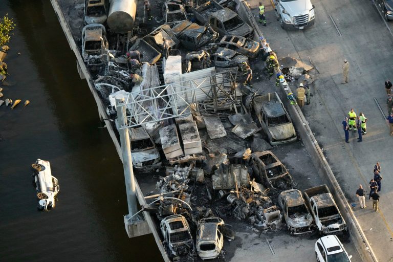 In this aerial photo, responders are seen near wreckage in the aftermath of a multivehicle pileup on I-55 in Manchac, Louisiana., Monday, Oct. 23, 2023. A âsuperfogâ of smoke from south Louisiana marsh fires and dense morning fog caused multiple traffic crashes involving scores of cars. 