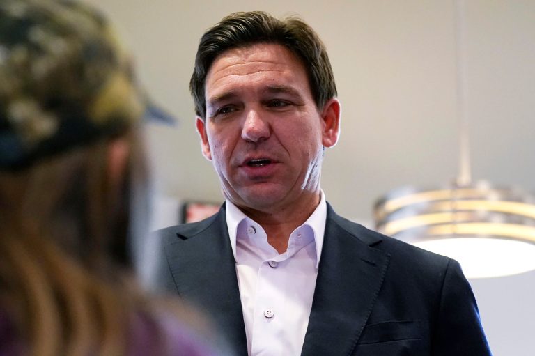 Gov. Ron DeSantis (R-FL) talks with a guest during a campaign stop at a diner, Tuesday, Oct. 24, 2023, in Londonderry, New Hampshire.