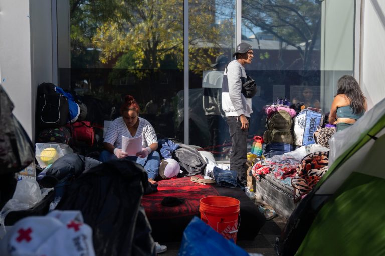 Migrants are camped outside of the 1st District police station, Saturday, Oct. 7, 2023, in Chicago.