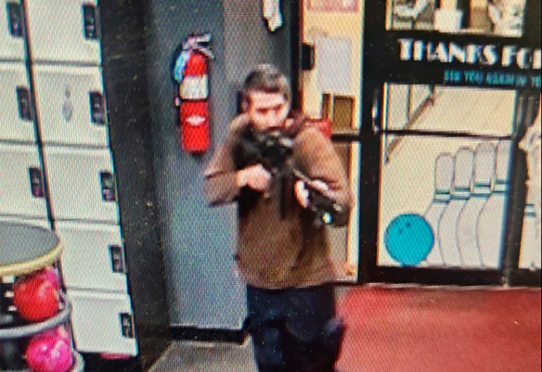 In this image taken from video released by the Androscoggin County Sheriff's Office, an unidentified gunman points a gun while entering Sparetime Recreation in Lewiston, Maine, on Wednesday, Oct. 25, 2023.