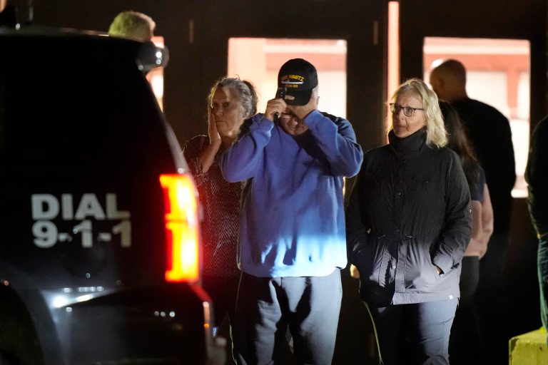 People depart a reunification center early Thursday, Oct. 26, 2023, at Auburn Middle School, in Auburn, Maine, after shootings in Lewiston.