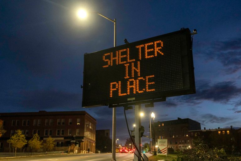 A sign advises residents to stay home, Thursday, Oct. 26, 2023, following a mass shooting at a restaurant and a bowling alley in Lewiston, Maine. Police continue to search for the suspect.