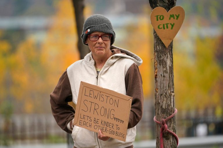 Jess Paquette expresses her support for her city in the wake of Wednesday's mass shootings at a restaurant and bowling alley, Thursday, Oct. 26, 2023, in Lewiston, Maine. Police continue their manhunt for the suspect. Authorities urged residents to lock themselves in their homes, and schools announced closures on Thursday.