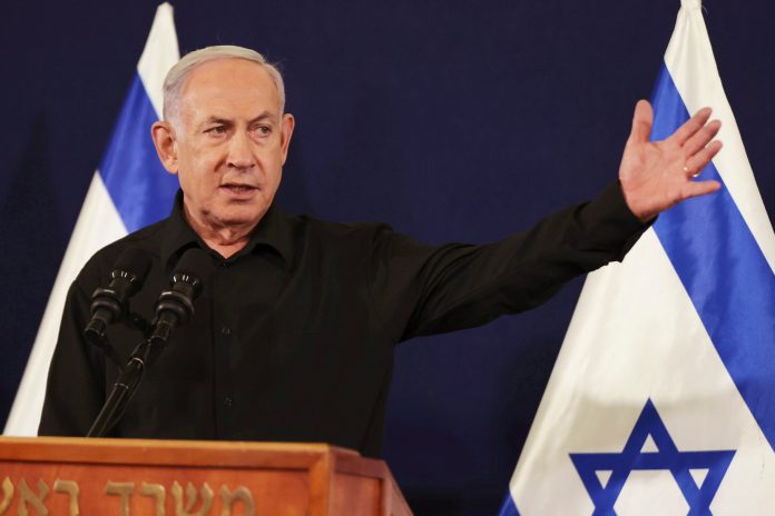 Israeli Prime Minister Benjamin Netanyahu speaks during a press conference with Defense Minister Yoav Gallant and Cabinet Minister Benny Gantz on Saturday, Oct. 28, 2023, in the Kirya military base in Tel Aviv, Israel.