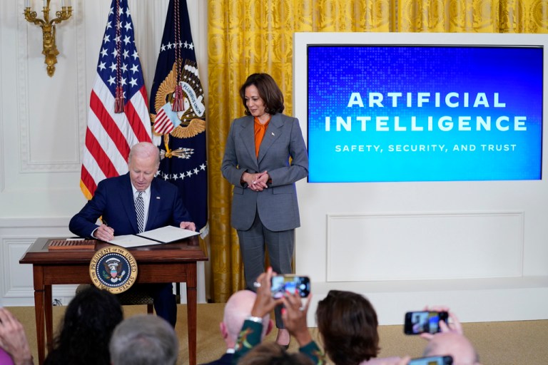 President Joe Biden signs an executive on artificial intelligence in the East Room of the White House, Monday, Oct. 30, 2023, in Washington as Vice President Kamala Harris looks on.