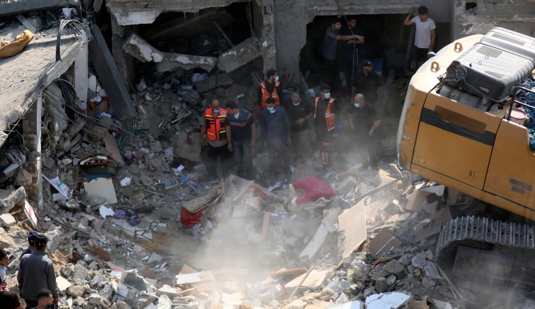 Palestinians inspect the damage of buildings that were targeted by Israeli airstrikes near Jabalia.