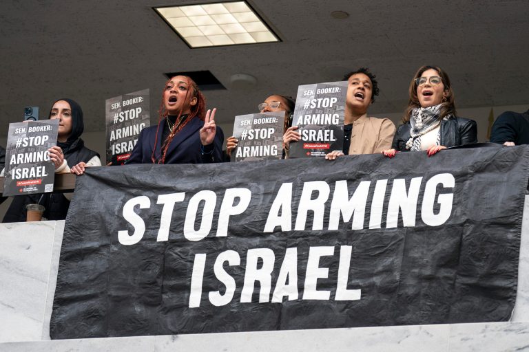 Anti-war activists demonstrate outside the office of Sen. Cory Booker, D-N.J., in the Hart Senate Office Bldg., just as the Republican-controlled House approved a partisan $14.5 billion military aid package for Israel, but without humanitarian assistance for Gaza, at the Capitol in Washington, Friday, Nov. 3, 2023. (AP Photo/J. Scott Applewhite)