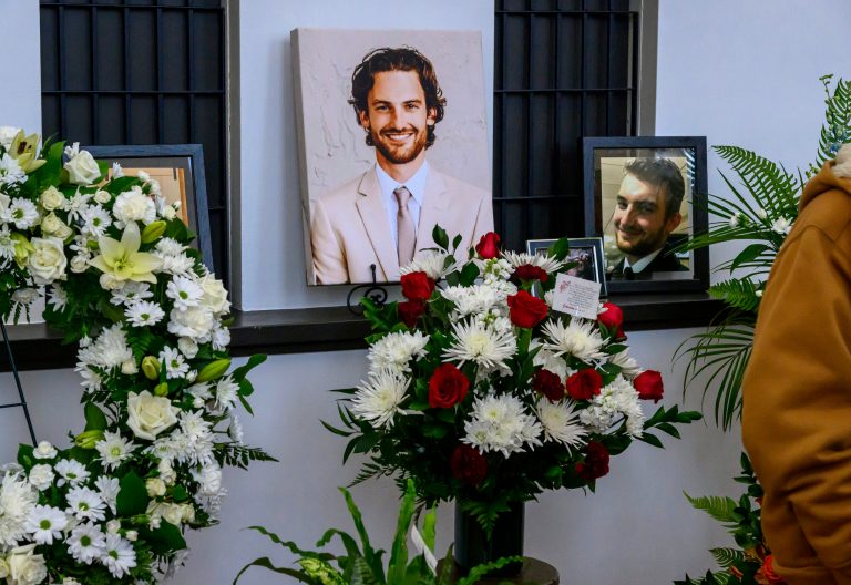 Photos of Adam Johnson line the ticket window booth at the Hibbing Memorial Building, in Hibbing, Minnesota.