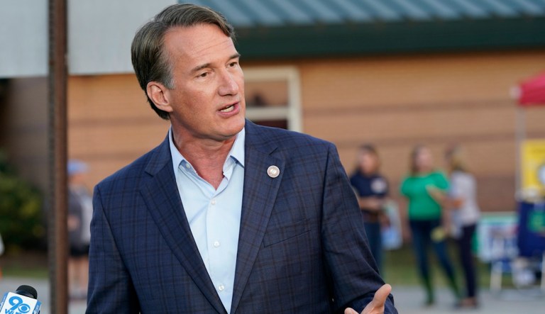 Gov. Glenn Youngkin (R-VA) gestures as he talks with reporters after greeting voters at a polling station Tuesday, Nov. 7, 2023, in Glenn Allen, Virginia,