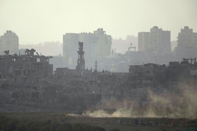 Israeli armed vehicles drive along the outskirts of Gaza City, as seen from southern Israel, Thursday Nov. 9, 2023.
