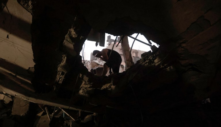 Palestinians look for survivors under the rubble of a destroyed house following an Israeli airstrike in Khan Younis refugee camp, southern Gaza Strip, Monday, Nov. 13, 2023.
