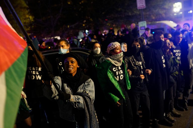 Demonstrators stand near the headquarters of the Democratic National Committee on Wednesday, Nov. 15, 2023, in Washington.