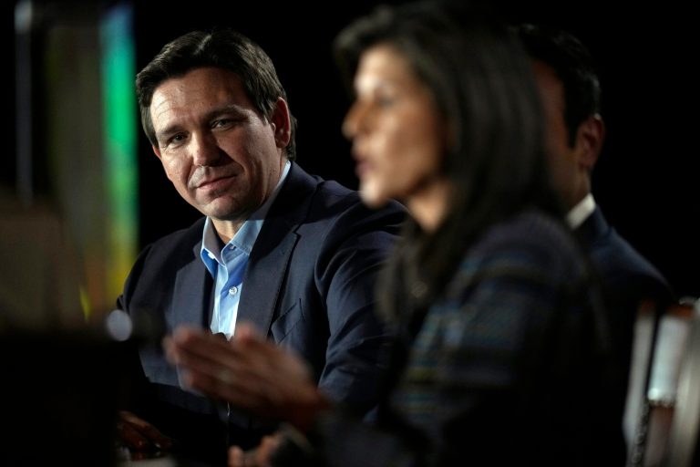 Gov. Ron DeSantis (R-FL), left, listens to former U.N. Ambassador Nikki Haley speak during the Family Leader's Thanksgiving Family Forum, Friday, Nov. 17, 2023, in Des Moines, Iowa.