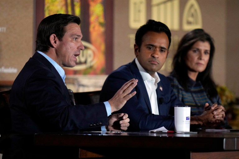 Gov. Ron DeSantis (R-FL) speaks during the Family Leader's Thanksgiving Family Forum as businessman Vivek Ramaswamy, center, and former U.N. Ambassador Nikki Haley, right, watch, Friday, Nov. 17, 2023, in Des Moines, Iowa. 