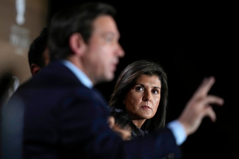 Former U.N. Ambassador Nikki Haley listens to Gov. Ron DeSantis (R-FL), left, speak during the Family Leader's Thanksgiving Family Forum, Friday, Nov. 17, 2023, in Des Moines, Iowa.