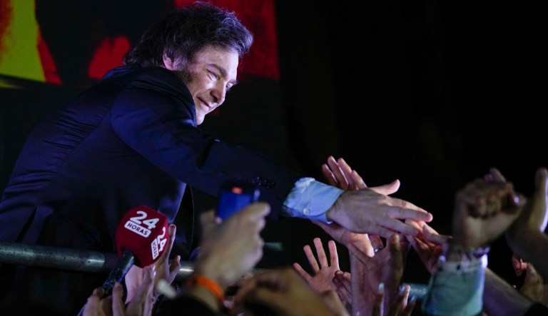 Presidential candidate of the Liberty Advances coalition Javier Milei greets supporters outside his campaign headquarters after winning the presidential runoff election in Buenos Aires, Argentina, Sunday, Nov. 19, 2023.