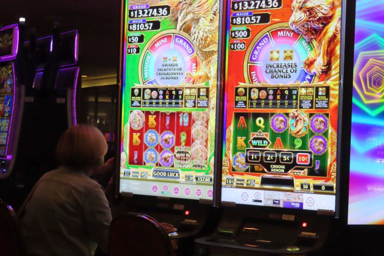 A gambler plays a slot machine at Harrah's casino in Atlantic City, N.J., on Sept. 29, 2023. (AP Photo/Wayne Parry)