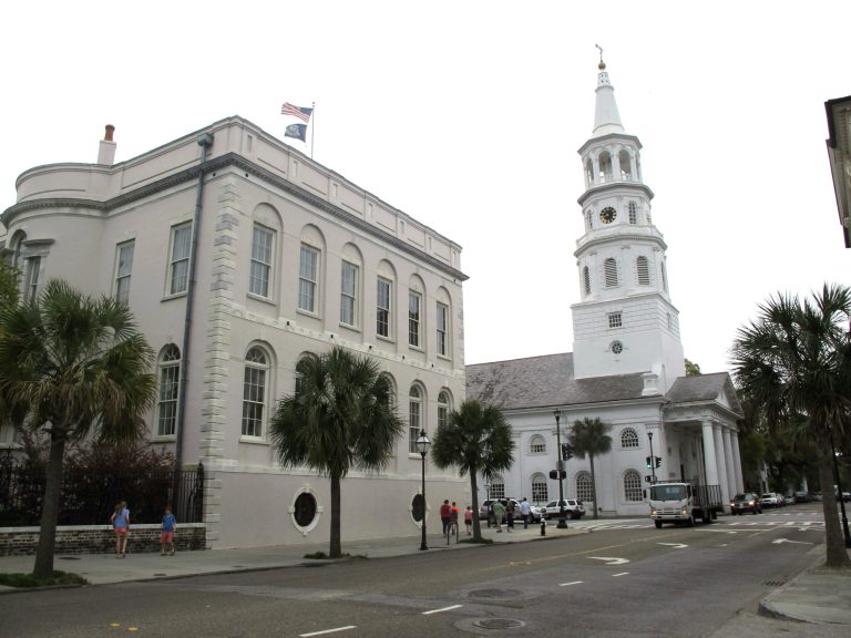 In an April 7, 2014 file photo, pedestrians walk by City Hall and St. Michael's Episcopal Church in Charleston, South Carolina.