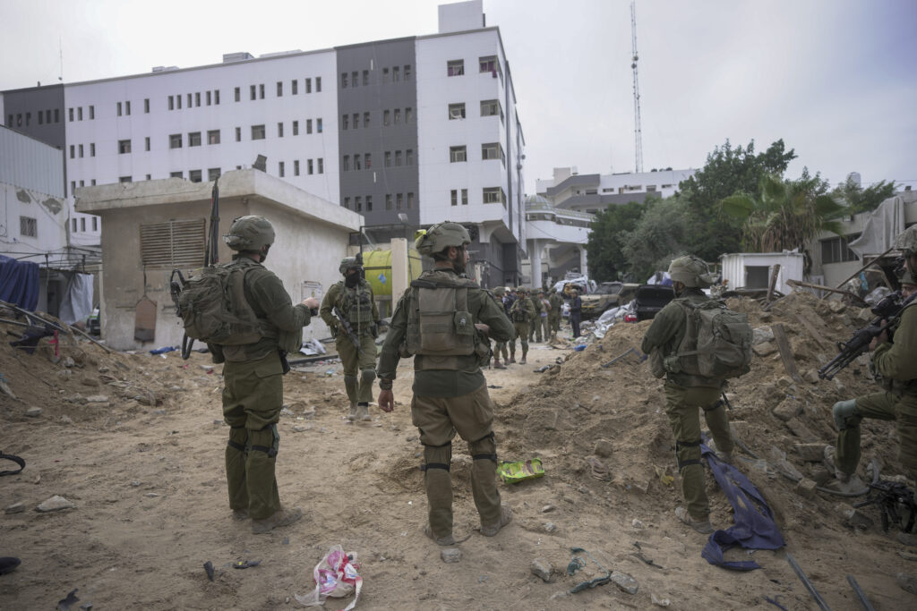 FILE - Israeli soldiers stand outside Shifa Hospital in Gaza City, Wednesday, Nov. 22, 2023. Ayah al-Wakeel, a lawyer, initially sought shelter at the hospital with her family but fled after an Israeli warning to leave. They returned to the hospital on Nov. 4 but she later texted that she felt unsafe and was going south. Israeli forces breached the hospital on Nov. 13. Al-Wakeel has not been heard from since.