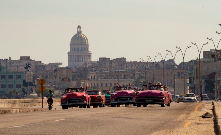 Classic and antique cars drive during the yearly Old Car Rally of Havana, in Havana, Cuba, Sunday, Dec. 3, 2023. The former US ambassador to Bolivia has been charged with espionage on behalf of Cuba.