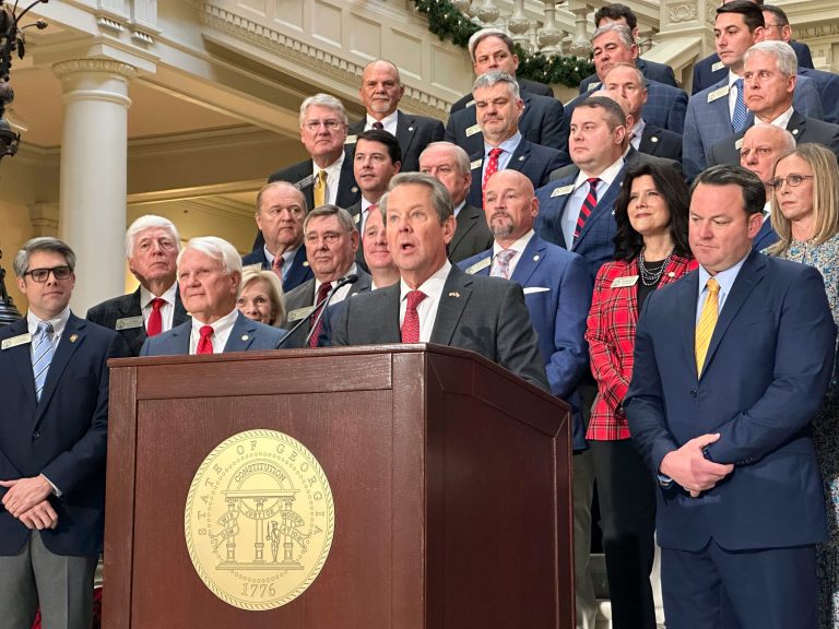 Gov. Brian Kemp (R-GA), flanked by Republican lawmakers, speaks Monday, Dec. 4, 2023, at the Georgia Capitol in Atlanta.