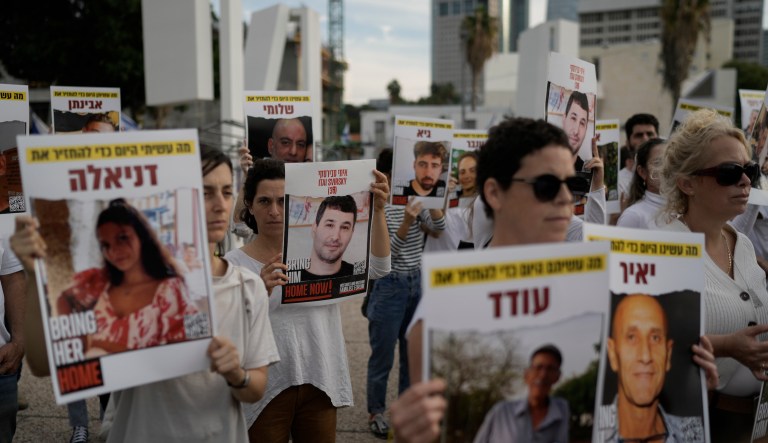 Relatives and friends of hostages held in the Gaza Strip by the Hamas militant group call for their release during the Jewish holiday of Hanukkah in the Hostages Square at the Museum of Art, in Tel Aviv, Israel, Friday, Dec. 8, 2023.