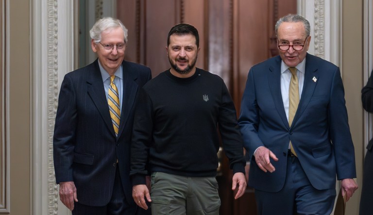 Ukrainian President Volodymyr Zelensky, center, is escorted by Senate Minority Leader Mitch McConnell (R-KY) left, and Senate Majority Leader Chuck Schumer (D-NY) at the Capitol, Dec. 12, 2023.