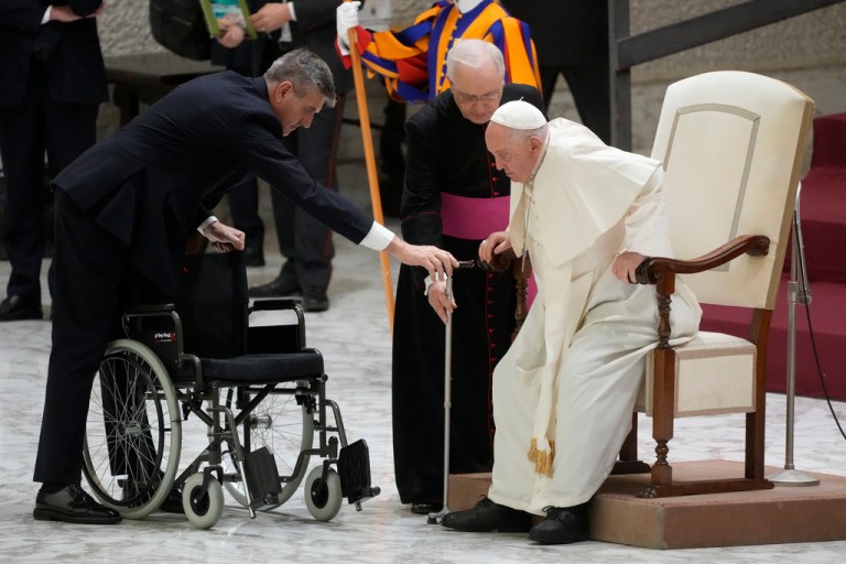 Pope Francis stands up during the weekly general audience at the Vatican on Wednesday, Dec. 13, 2023.