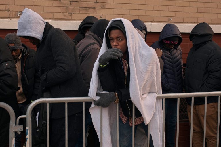 Migrants queue in the cold as they look for a shelter outside a migrant assistance center at St. Brigid Elementary School on Dec. 5, 2023, in New York. It could be a cold, grim new year for thousands of migrant families living in New York Cityâs emergency shelter system. With winter setting in, they are being told they need to clear out, with no guarantee theyâll be given a bed elsewhere.  