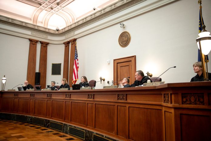 Oregon Supreme Court justices listen to the oral arguments made by attorneys representing Republican Oregon senators and the Department of Justice on Thursday, Dec. 14, 2023 in Salem, Oregon. Republicans are challenging the implementation of Measure 113, an effort to put a stop to legislative walkouts. 
