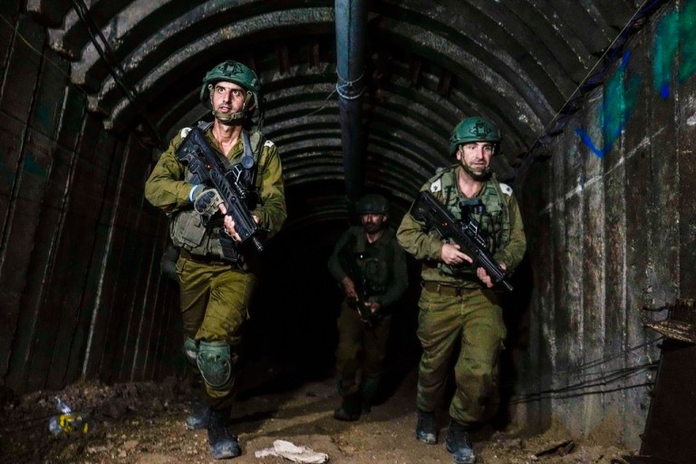 Israeli soldiers are seen in a tunnel that the military says Hamas militants used to attack the Erez crossing in the northern Gaza Strip, Friday, Dec. 15, 2023. 