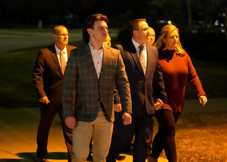 Paramedics Jeremy Cooper, third from right, and Peter Cichuniec, back left, enter the Adams County, Colo., Justice Center, Friday, Dec. 22, 2023, in Brighton, Colo. The two paramedics were convicted Friday in the 2019 killing of Elijah McClain, who they injected with an overdose of theÂ sedative ketamineÂ after police put him in a neck hold. 