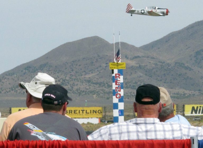 Fans watch Rob Sandberg of Seattle cross the finish line in his SNJ-4 