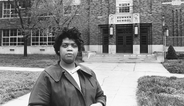 This May 8, 1964 file photo shows Linda Brown Smith standing in front of the Sumner School in Topeka, Kansas. The refusal of the public school to admit Brown in 1951, then nine years old, because she is black, led to the Brown v. Board of Education of Topeka, Kansas. In 1954, the U.S. Supreme Court overruled the 