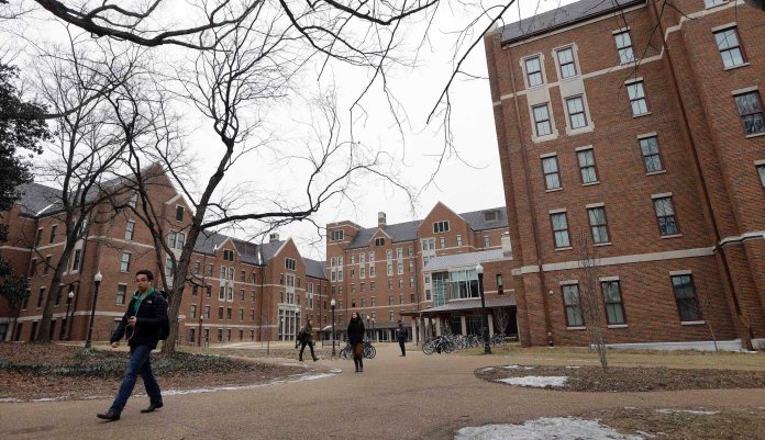 In this Feb. 24, 2015 photo, students walk through the Warren College and Moore College area at Vanderbilt University on Tuesday, Feb. 24, 2015, in Nashville, Tenn. Vanderbilt is one of a small but growing number of U.S. colleges and universities that have embraced a "residential college" model where students become part of a close-knit but diverse community that enhances both their academic and social lives.